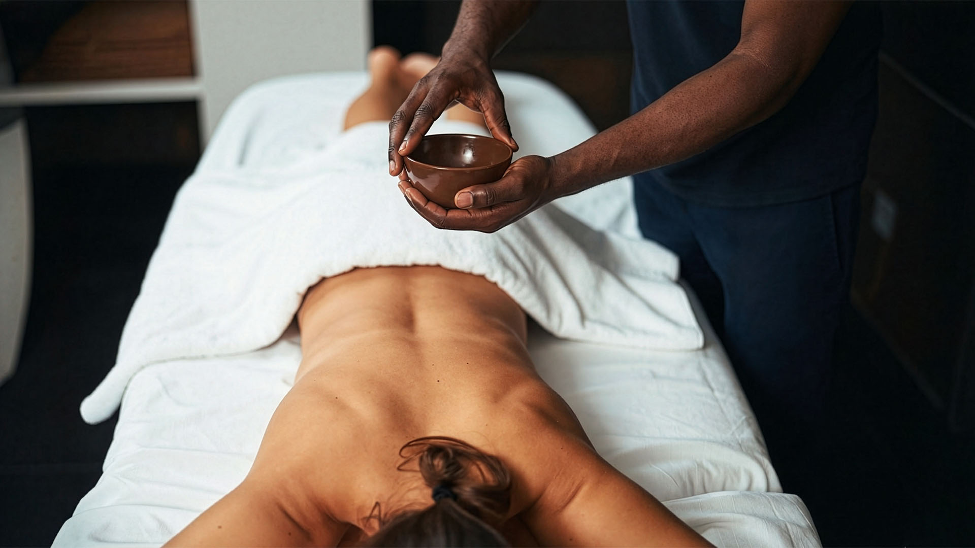 Woman experiencing peaceful relaxation during aromatherapy massage for nervous system reset and stress relief